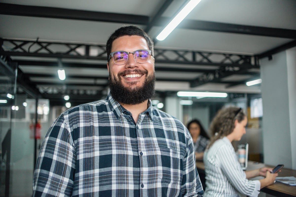 Portrait of young businessman and a coworking space