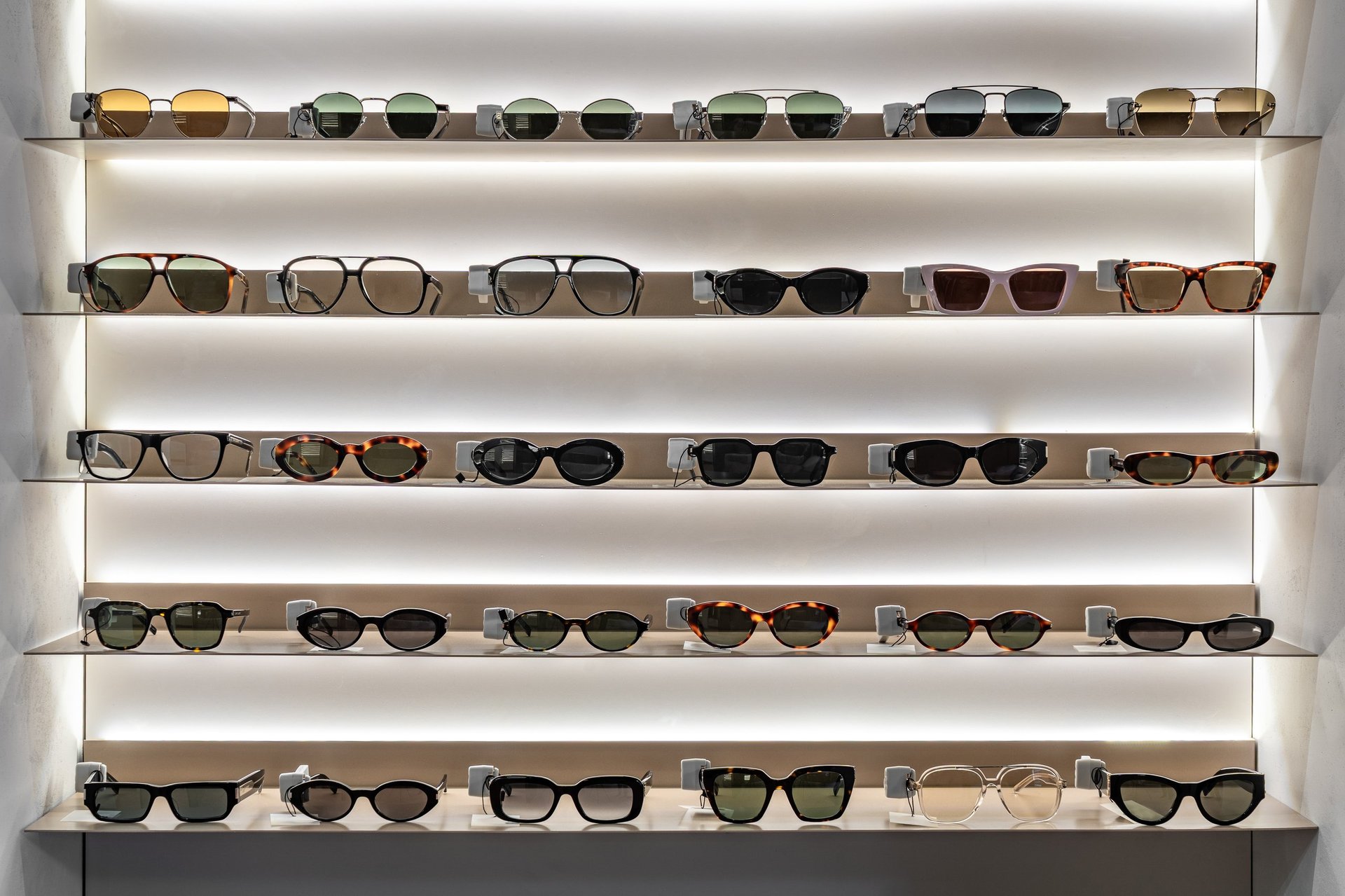 Modern optical store interior with sunglasses and eyeglasses display